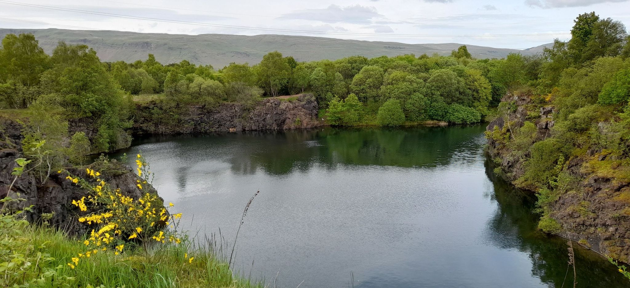 Campsie Fells beyond Peitches Moor and quarry loch in Mugdock Country Park